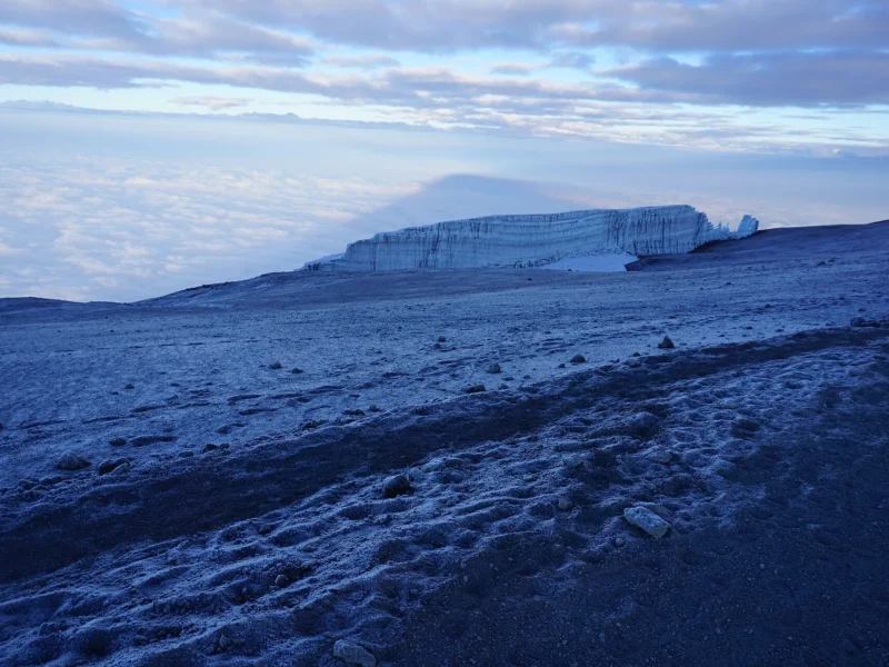 Summit glacier on Mount Kilimanjaro at sunrise above the clouds
