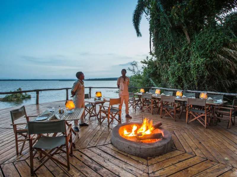Deck and fire pit on the shore of Lake Ihema at Ruzizi Tented Lodge