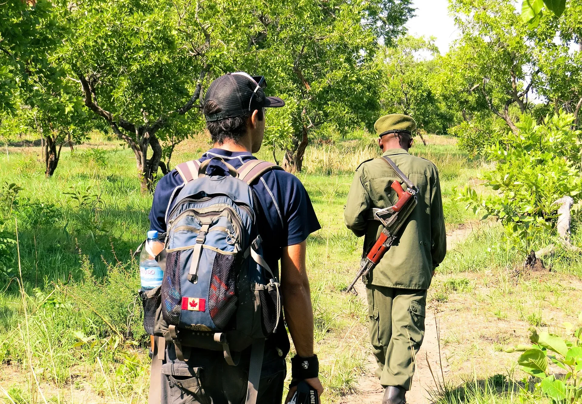 Visitor on a walking safari following an armed ranger in Katavi National Park